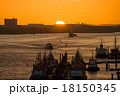 Various ships  in a harbor at sunset 18150345