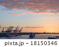 Cranes in a harbor at sunset 18150346