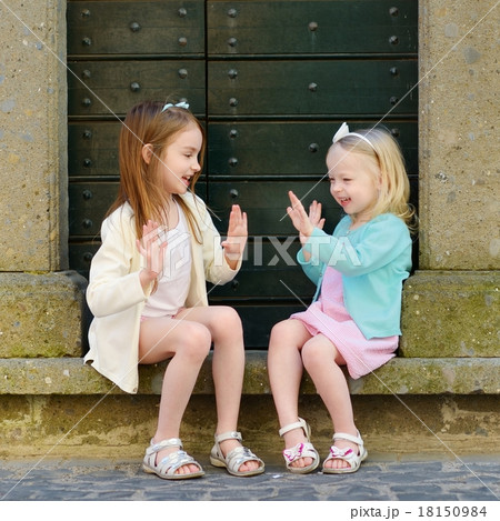 Two adorable little sisters having fun together 18150984