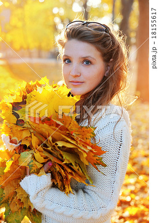 Beautiful woman spending time in park during autumn season Beautiful woman spending time in park during autumn season 18155617
