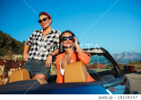 Two young girls having fun in the cabriolet outdoors Two young girls having fun in the cabriolet outdoors 18156547