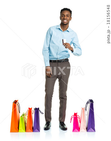 Happy african american man with shopping bags and holding credit Happy african american man with shopping bags and holding credit 18156548