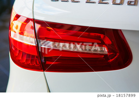 Back view and red headlight of white automobile 18157899