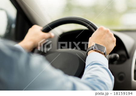 close up of man with wristwatch driving car 18159194