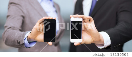 businessman and businesswoman with smartphones businessman and businesswoman with smartphones 18159502