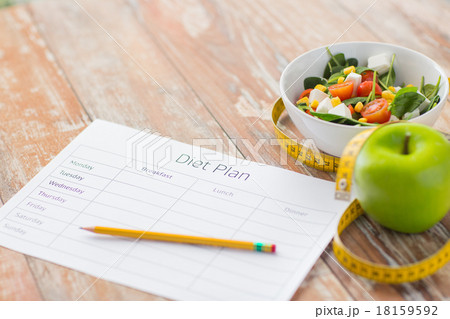 close up of diet plan and food on table 18159592
