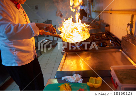chef in hotel kitchen prepare food with fire 18160123