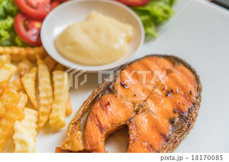 Grilled salmon steak meal served with salad and French fries 18170085