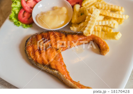 Grilled salmon steak meal served with salad and French fries 18170428