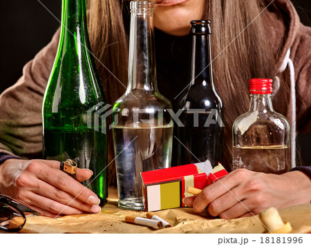 Girl drinking alcohol and smokes cigarettes. Girl drinking alcohol and smokes cigarettes. 18181996