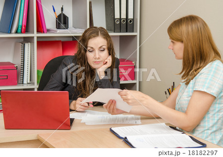 Girl shows a document tired office specialist 18182297