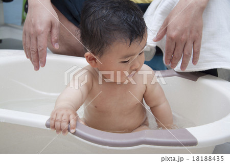 Chinese father washing baby in bathtub Chinese father washing baby in bathtub 18188435