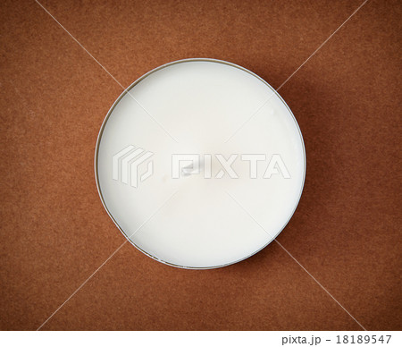 Round candle on the brown background Round candle on the brown background 18189547