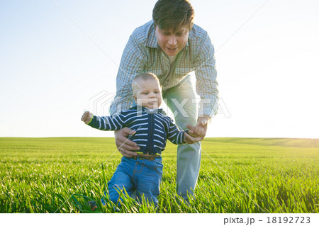 Young father and his son having fun, playing on 18192723