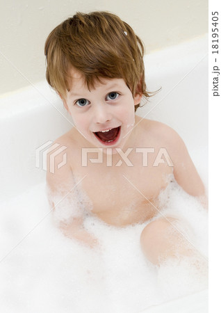 Cute three year old boy taking a bath with foam Cute three year old boy taking a bath with foam 18195405