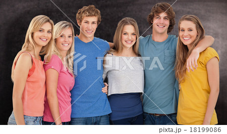 Composite image of a group of friends smiling and holding each o 18199086