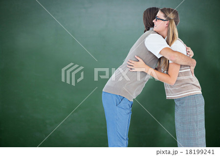 Composite image of geeky hipster couple hugging 18199241