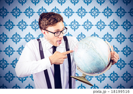 Composite image of geeky businessman pointing to globe 18199516