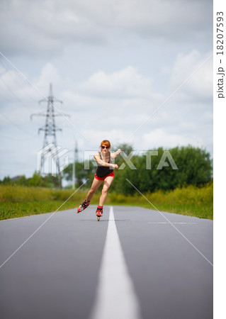 Attractive girl rollerblading on the road Attractive girl rollerblading on the road 18207593
