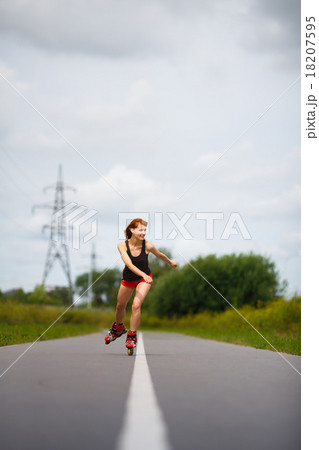 Attractive girl rollerblading on the road Attractive girl rollerblading on the road 18207595