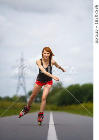 Attractive girl rollerblading on the road 18207596