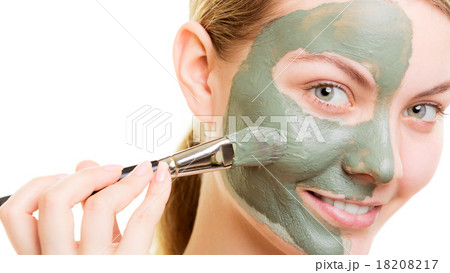 Woman applying with brush clay mud mask her face Woman applying with brush clay mud mask her face 18208217