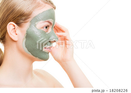 Woman in clay mud mask on face isolated on white. 18208226