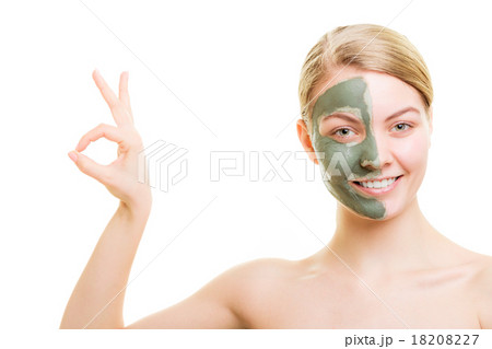 Woman in clay mud mask on face isolated on white. 18208227