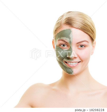 Woman in clay mud mask on face isolated on white. 18208228