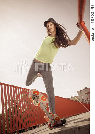 Teen girl skater riding skateboard on street. Teen girl skater riding skateboard on street. 18208593