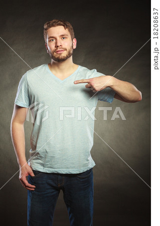 Man guy in blank shirt with copy space pointing. 18208637