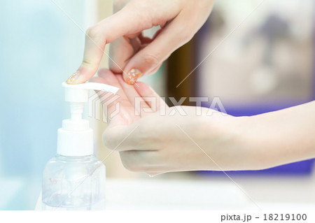 woman hand using sanitizer gel at hospital 18219100