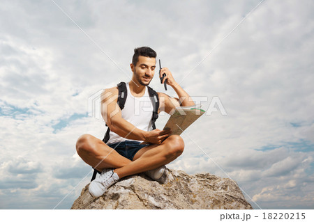 Young man tourist with a backpack Young man tourist with a backpack 18220215