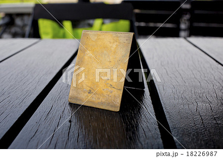 Blank old brown leather table card on wood table. 18226987