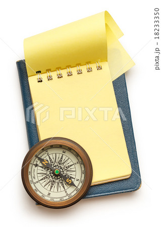 Vintage compass and blank yellow notepad Vintage compass and blank yellow notepad 18233350