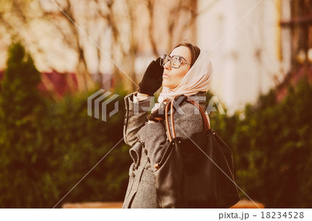 Happy young beautiful girl posing in the park Happy young beautiful girl posing in the park 18234528