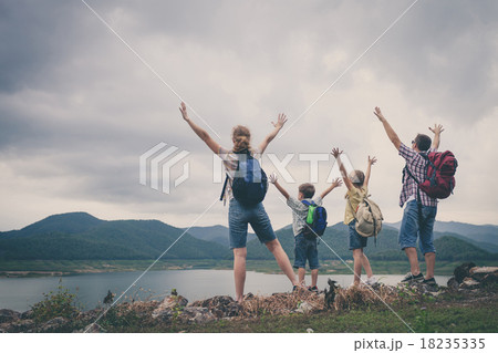 Happy family standing near the lake. 18235335