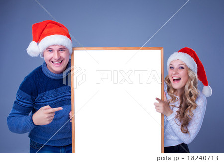 Christmas couple holding white board with empty 18240713