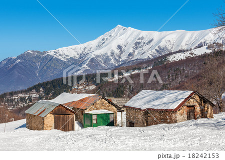 Rural houses and snowy mountains in Italy. 18242153