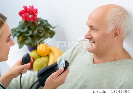 Young granddaughter uses stethoscope to check 18243496