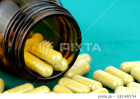 Dried herb capsule on green cloth background. Dried herb capsule on green cloth background. 18248554