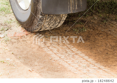 Four wheel drive tire with tracks on dry dirt road 18248642