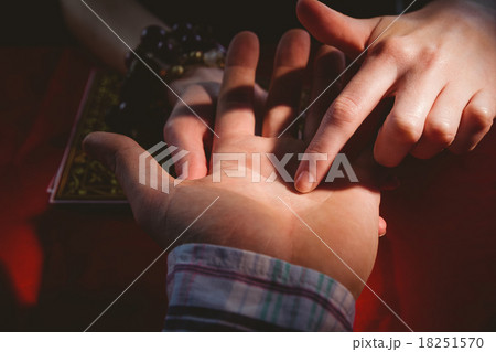 Fortune teller reading mans palm 18251570