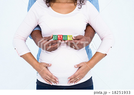 Midsection of husband with wife holding baby text Midsection of husband with wife holding baby text 18251933