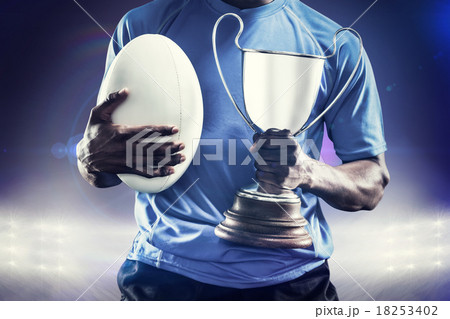 Composite image of mid section of sportsman holding trophy and r 18253402