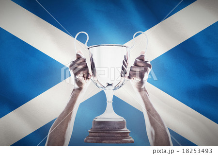 Composite image of cropped hand of athlete holding trophy Composite image of cropped hand of athlete holding trophy 18253493