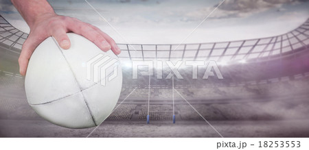 Composite image of a rugby player posing a rugby ball 18253553