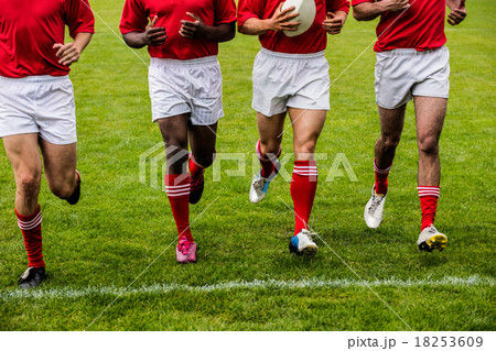 Rugby players jogging with ball 18253609