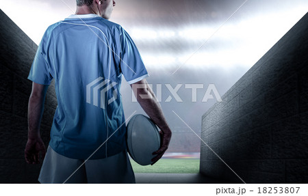 Composite image of rugby player holding a rugby ball 18253807