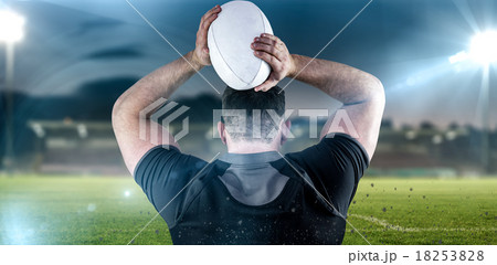 Composite image of tough rugby player throwing ball Composite image of tough rugby player throwing ball 18253828